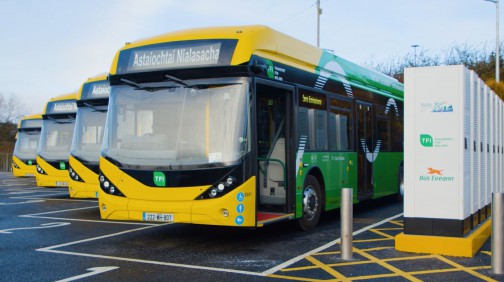 Yellow and green Electric Buses parked up at charging stations in Bus Éireann's Athlone depot